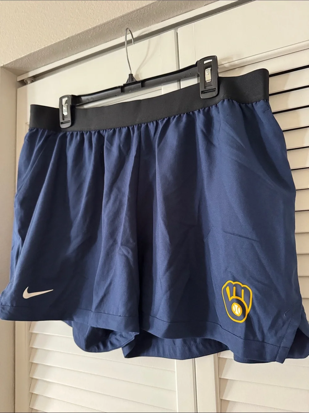 Nike Women's Navy Blue Athletic Skort with Black Waistband and Yellow Logo